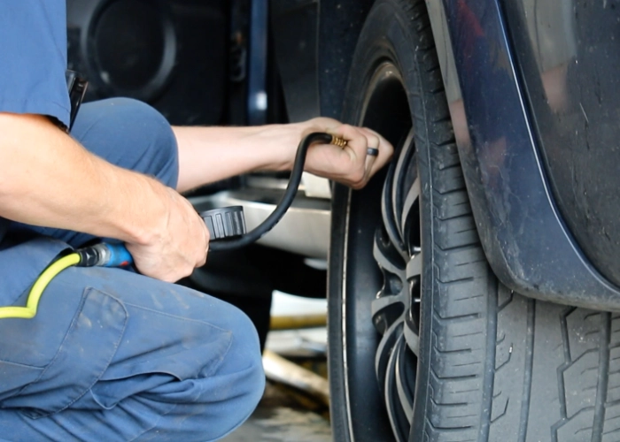 An employee filling a tire